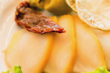 Thin slices of sturgeon fillet on plate close
