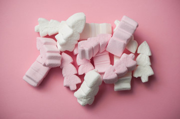 closeup of pink and white marshmallows in shaped fir on pink background