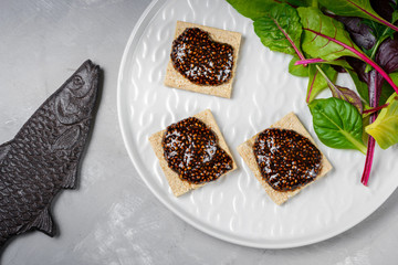 Vegan caviar made with chia seeds and nori. Appetizers on whole grain crispbreads