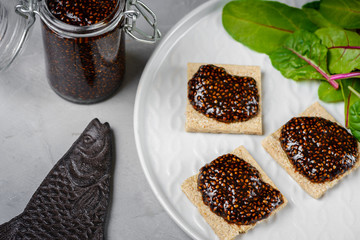 Vegan caviar made with chia seeds and nori. Appetizers on whole grain crispbreads