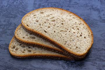 Sliced bread, on a wooden surface. Bread assortment on wooden surface