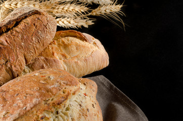 loaf of bread on black background, food close up
