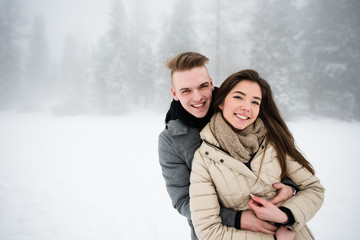 Portrait of young smiling couple hugging