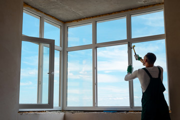 Builder is installing a window.