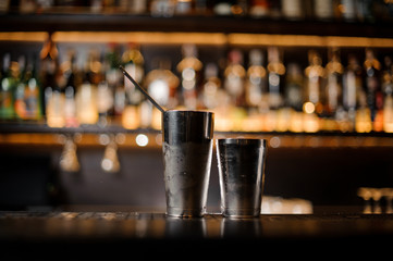 Steel shaker standing on the empty bar counter