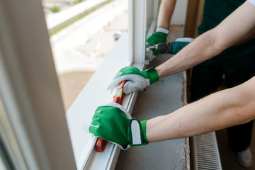 Worker's hands holding a level