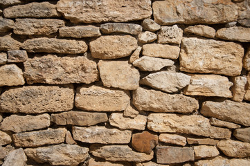 old stone wall illuminated by the sun