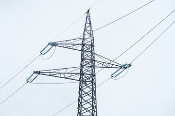 high-voltage tower on a grey sky of background