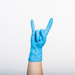 Hand sign rock-n-roll on white background, close up.