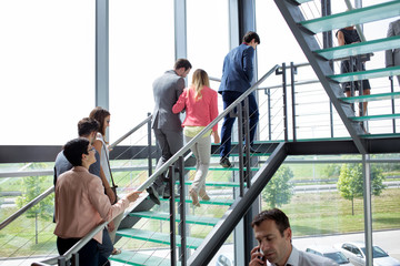 group of busy office workers walking on stairs.