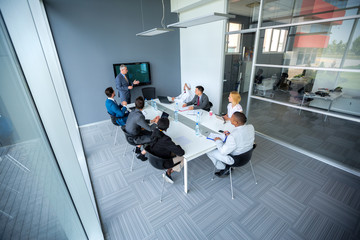 Company meeting with manager in meeting room