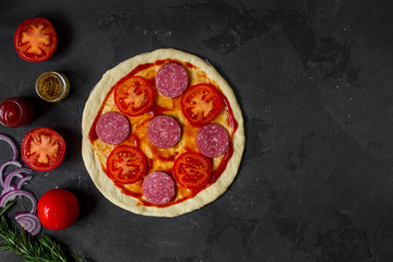 pizza, dough, ingredients, pepperoni, cheese, toatny sauce (cooking process). Top view with copy space