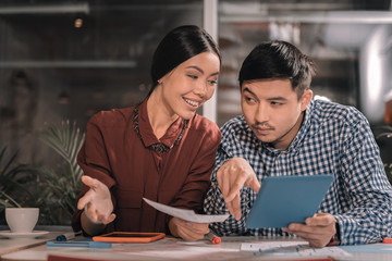 Dark-eyed husband having hesitations about business plan of his wife