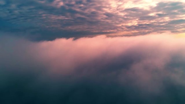 Aerial view of clouds and sky. Drone flies very high in evening sky. Romantic nature landscape