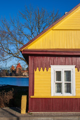 Medieval castle of Trakai with old wooden yellow house, Vilnius, Lithuania, Eastern Europe, located between beautiful lakes and nature 