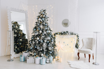 Very cozy and modern Christmas interior design idea with gorgeous Christmas tree, lights and a fireplace