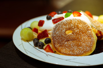 Pancake with strawberry, blueberry, banana, berry sauce and mascarpone cheese cream.