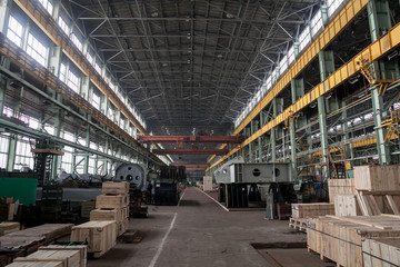 The interior of a big industrial building or factory with steel constructions