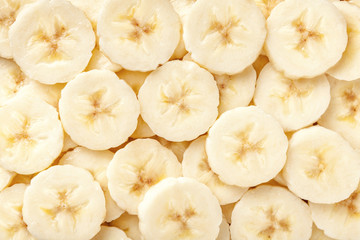 Background of ripe sliced banana slices, closeup.