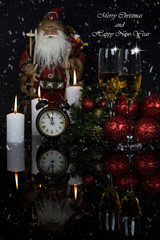 Two glasses with champagne,clock and Christmas ornaments