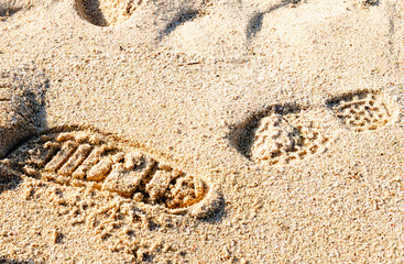 Human footprints on sand background. Close up of the footprint in the sand footprint in the beach Footprints in the sand at sunset