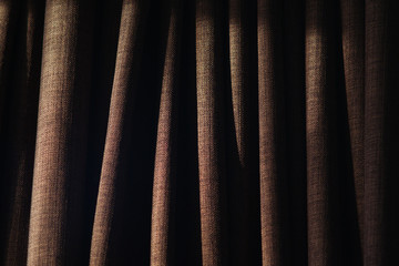 Closeup of folds on curtain with side lighting