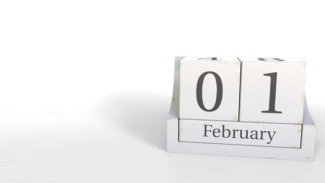 Wood cube calendar shows February 1 date, 3D animation