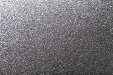 Textural of gray background of wavy corrugated paper, closeup.