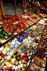 Christmas ornaments and other decorations displayed in colorful boxes. 