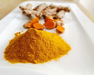 Kurkuma Gewürz Pulver, geschitten und als Knolle Textfreiraum