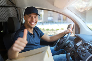 Delivery man sitting in a delivery van