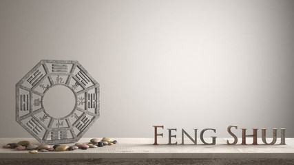 Wooden vintage table shelf with ba gua and 3d letters making the word feng shui with white blank...