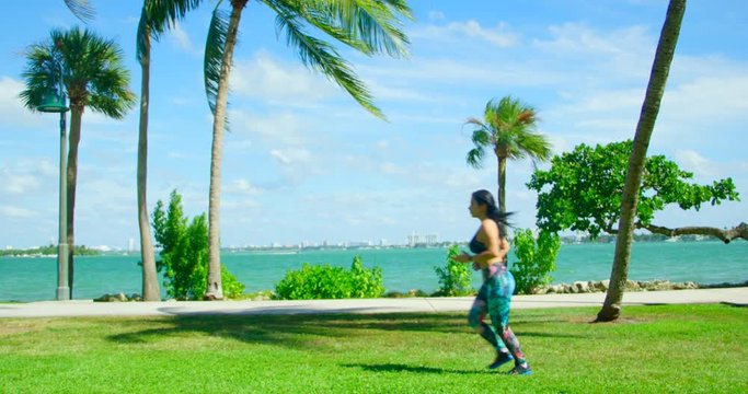 YOUNG FIT GIRL WORKING OUT IN FRONT OF THE OCEAN