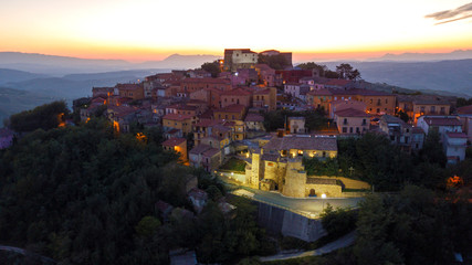 Aerial view at sunset of the small town of Montecalvo Irpino, in the province of Avellino, in Italy. This village with few houses and streets is built in the mountains of Irpinia