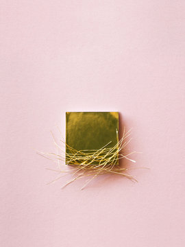 Gold Square And Gold Threads On Pink Background