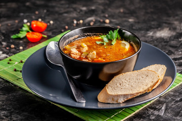 The concept of traditional Italian cuisine. Fish soup kachukko, with sea products, tomatoes and...