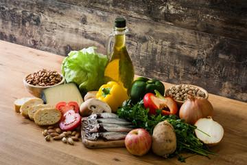 Healthy eating. Mediterranean diet. Fruit,vegetables, grain, nuts olive oil and fish on wooden table