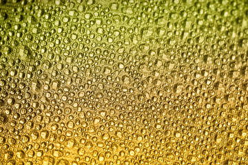 Drops of water on a color background. Orange. Shallow depth of field. Selective focus. Toned