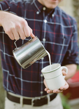 barista pouring latte