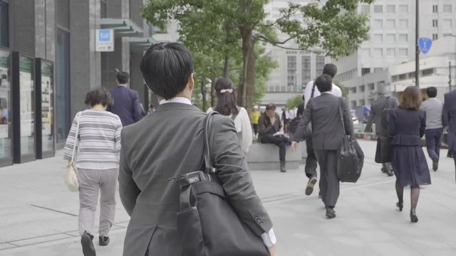 Men in business suits crossing the street in Tokyo,Japan