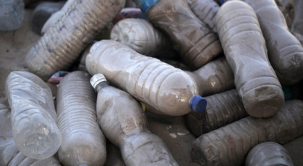 ecology: eco brick - bottles filled with sand
