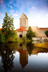 Fototapeta na wymiar Historic old town of Dinkelsbuhl, reflecting in the river. landmark at the romantic road middle Franconia, Germany