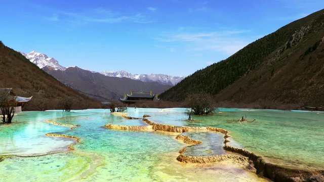 The Yellow Dragon Taoist Temple and travertine landscapes and pools of Huanglong (literally: Yellow Dragon), Sichuan, China. Huanglong was declared a World Heritage Site by UNESCO in 1992.