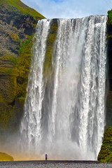 A lonely person at Skogafoss waterfall in Southern Iceland