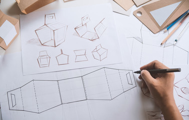 Designer sketching drawing design Brown craft cardboard paper product eco packaging mockup box...
