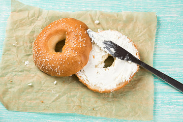 Fresh homemade bagel sandwiches with low fat cream cheese. Healthy breakfast food on rustic wooden background