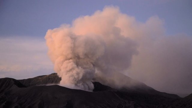Travel destination Mt Bromo volcano erupting smoke cloud in Java Indonesia