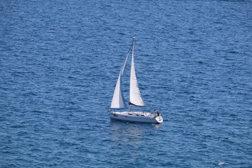 White sailboat on open blue sea in Portoroz, Slovenia