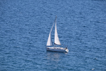 White sailboat on open blue sea in Portoroz, Slovenia