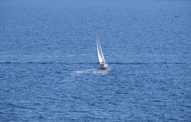 White sailboat on open blue sea in Portoroz, Slovenia
